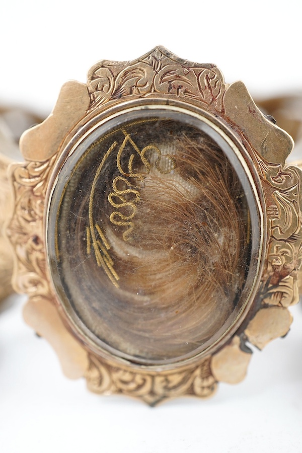 A Victorian yellow metal mounted plaited hair bracelet and two similar rings. Condition - poor